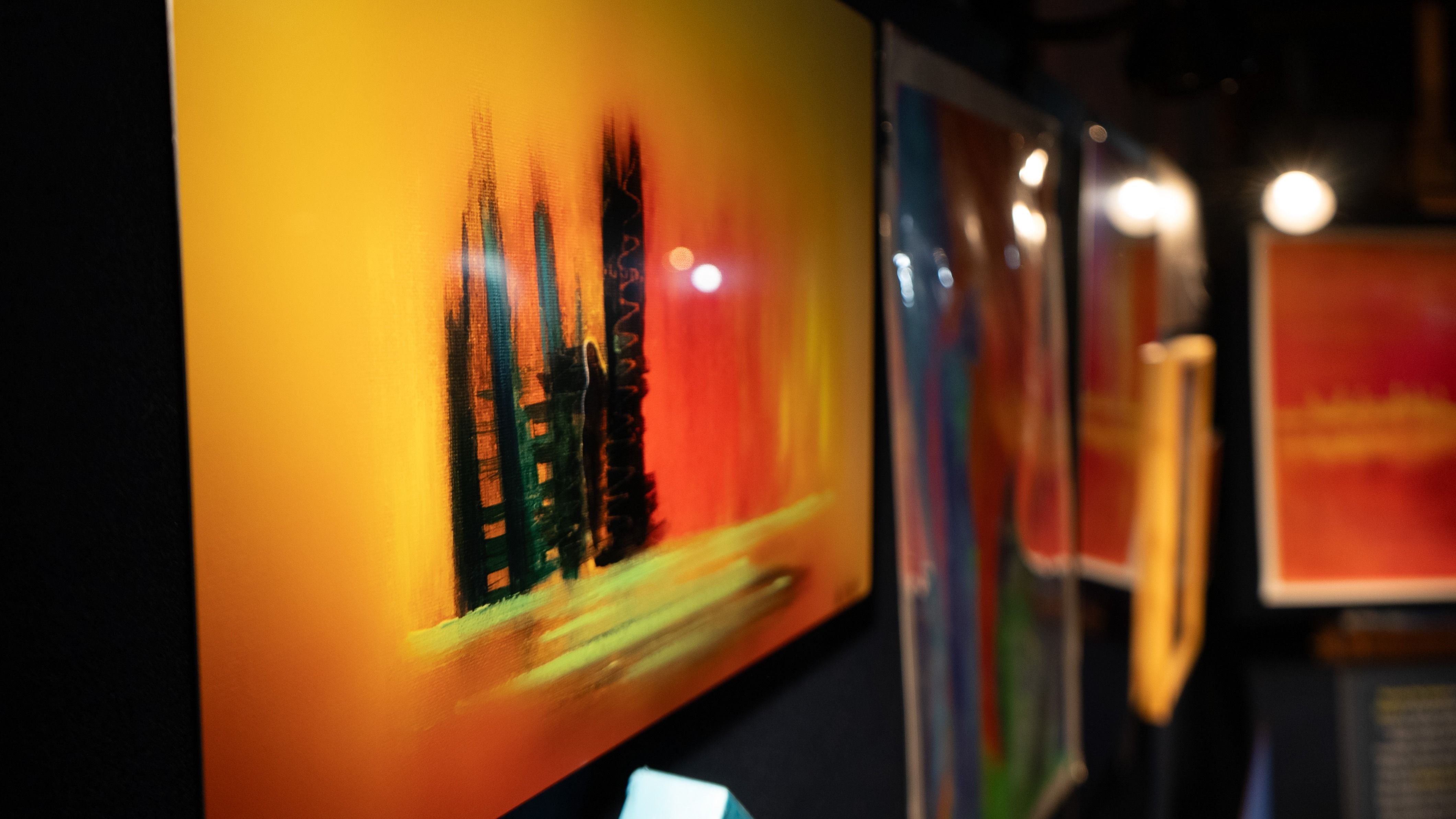 Cleft 2 metal print by Anne Reid Artist shown at RAW Toronto art show in a dark immersive gallery setting.