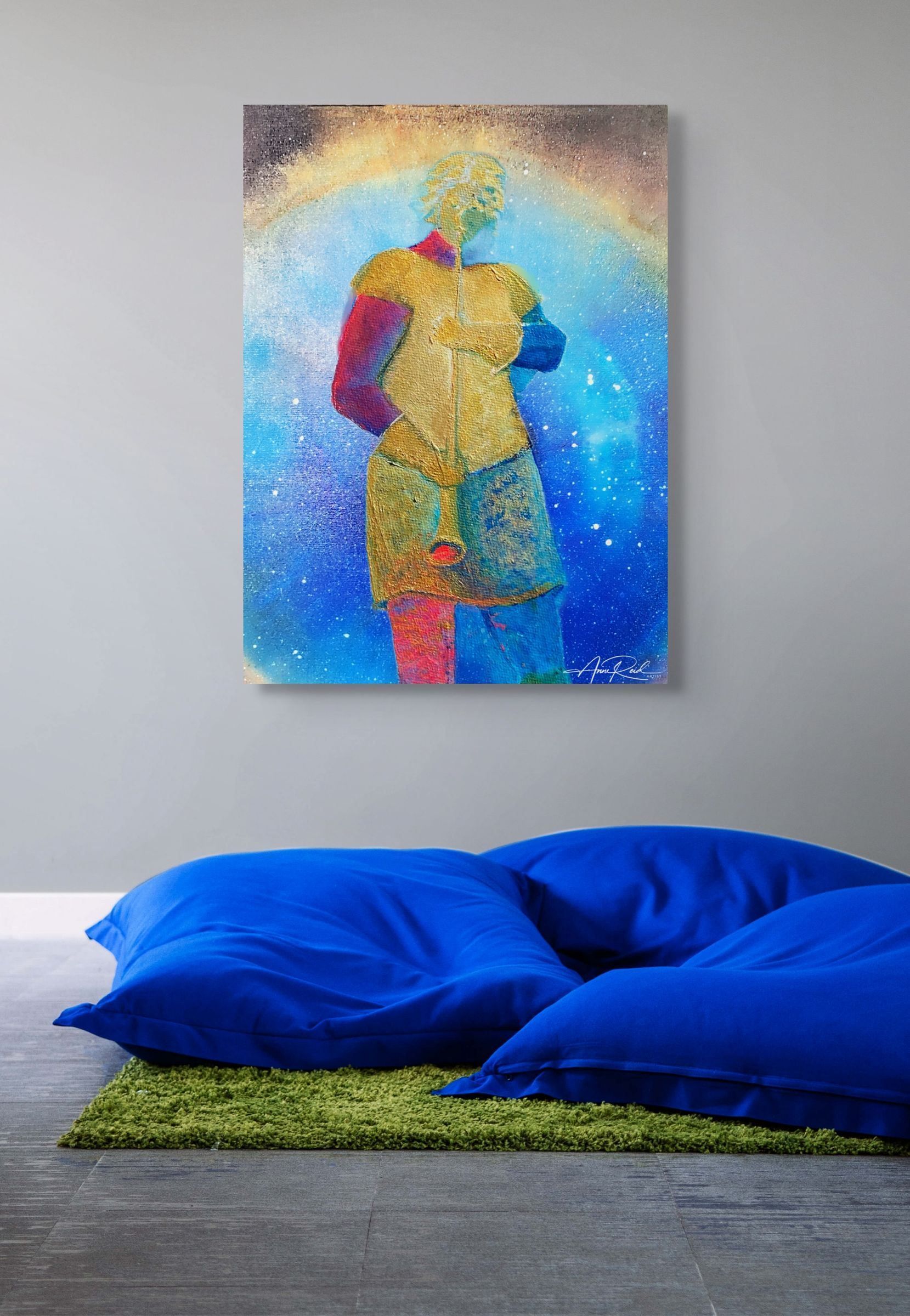 Herald 117 open edition fine art print by Anne Reid Artist — gold herald figure against cobalt-blue and turquoise starfield with golden arc overhead, shown in a prayer space with grey walls, green rug, and cobalt blue floor cushions.