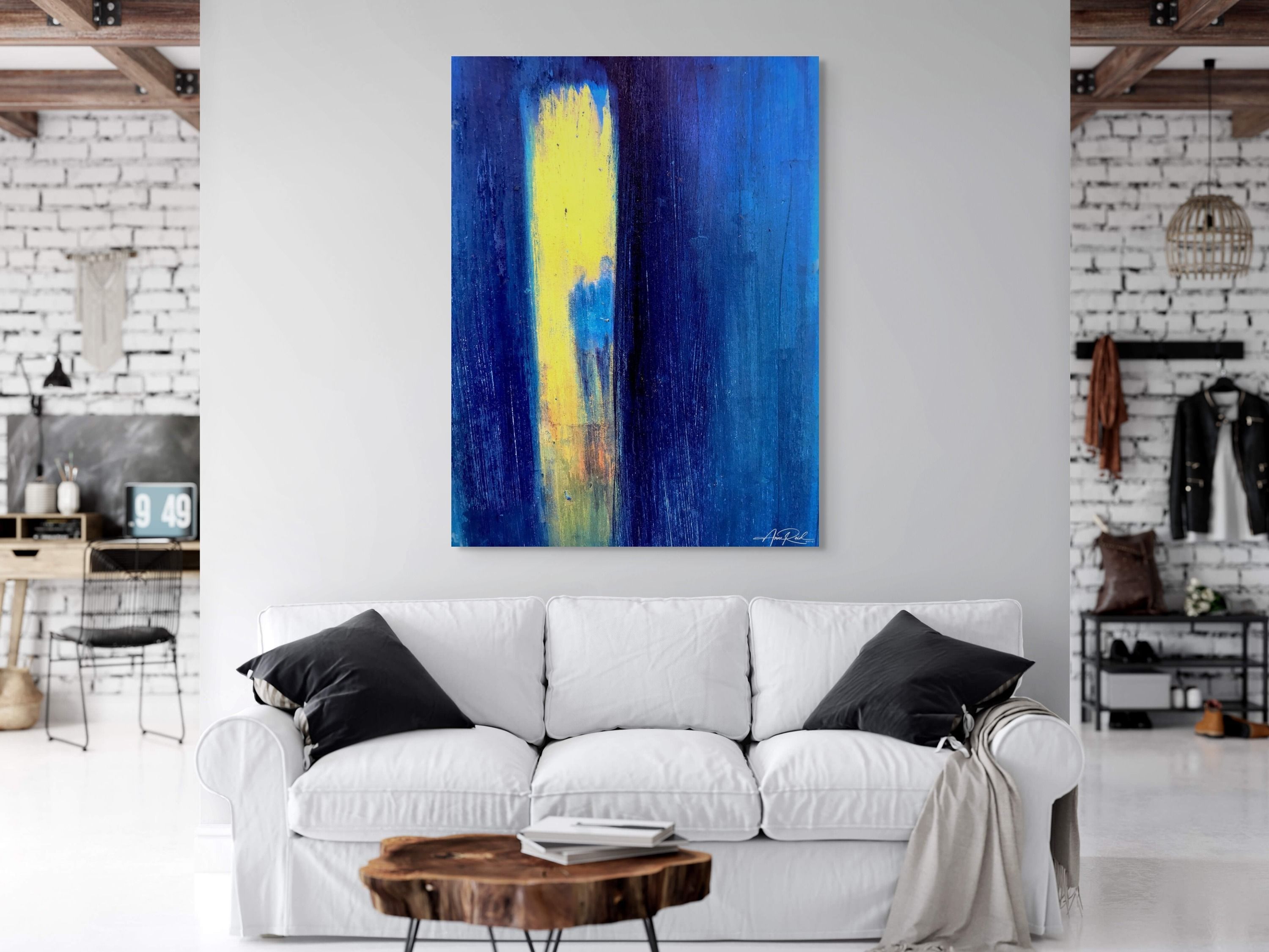 Golden Opportunity, fine art print by Anne Reid Artist shown at large scale on a white brick wall above a white sofa in a modern loft setting with exposed timber ceiling beams.