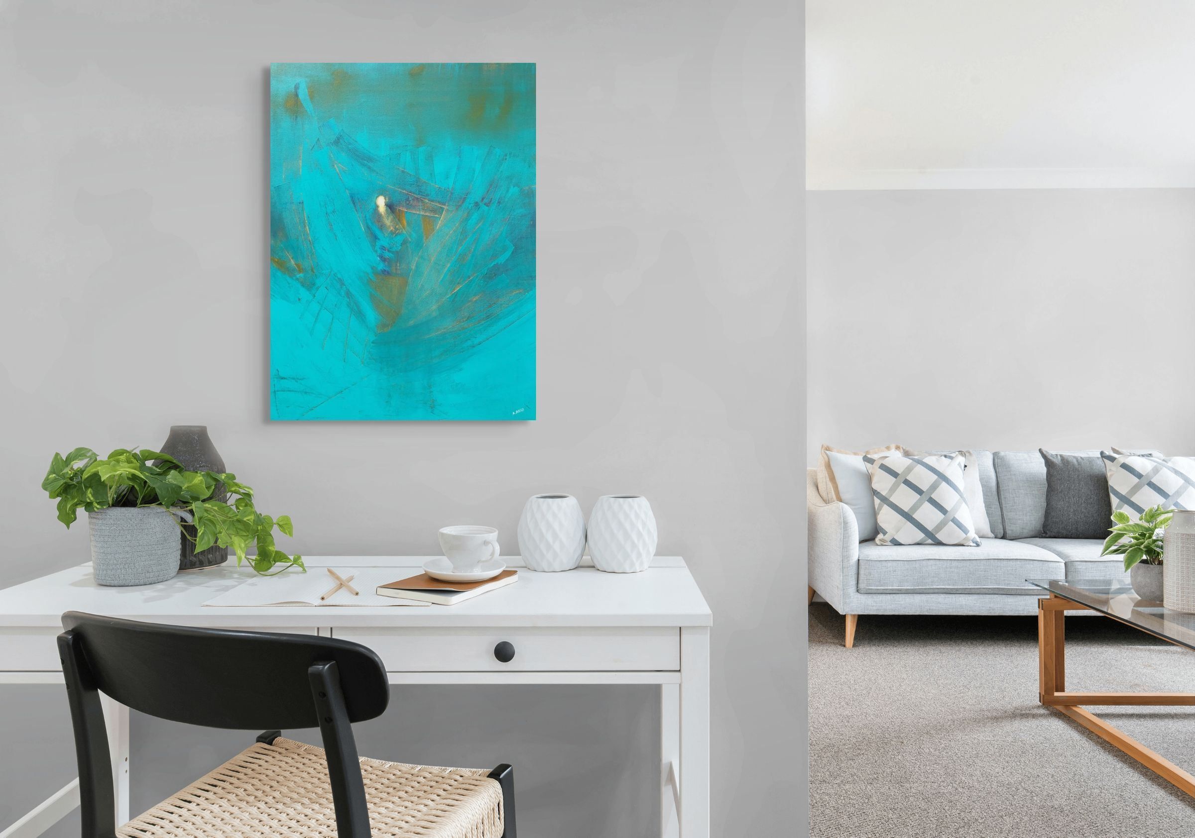 Elijah open edition fine art print by Anne Reid Artist — vivid turquoise with angular wing-like forms and gold center, shown above a white desk in a modern Scandinavian home office with grey walls and a rattan chair.