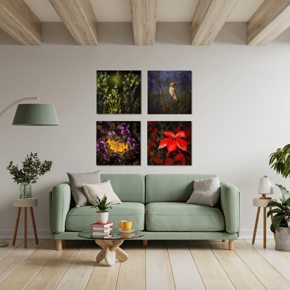 Four colorful 12x12 artworks from the Hudson Taconic Art Collection hang above an aqua sofa on a white wall under a ceiling with large, lightly stained wood beams.